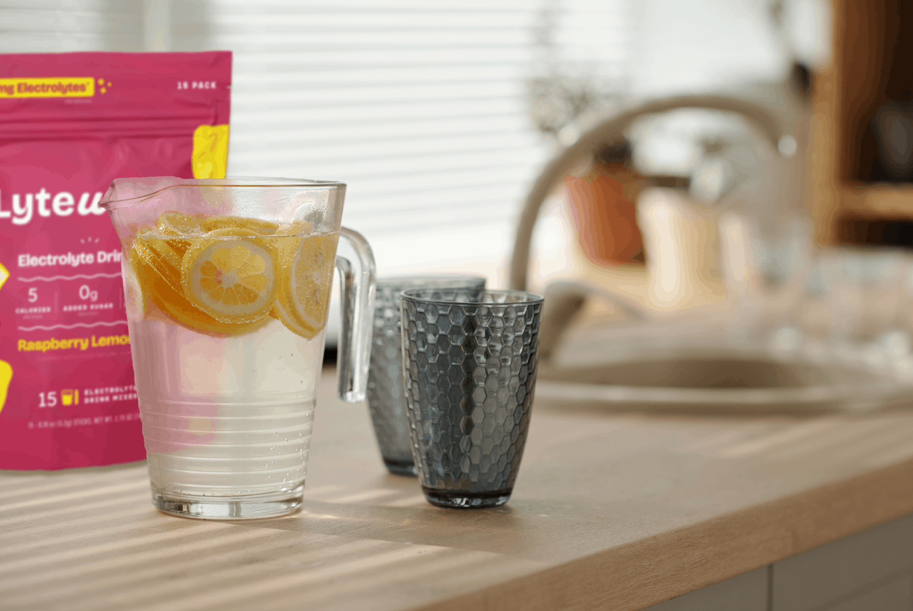 Glass of lemon water with Lytewave on a kitchen counter.